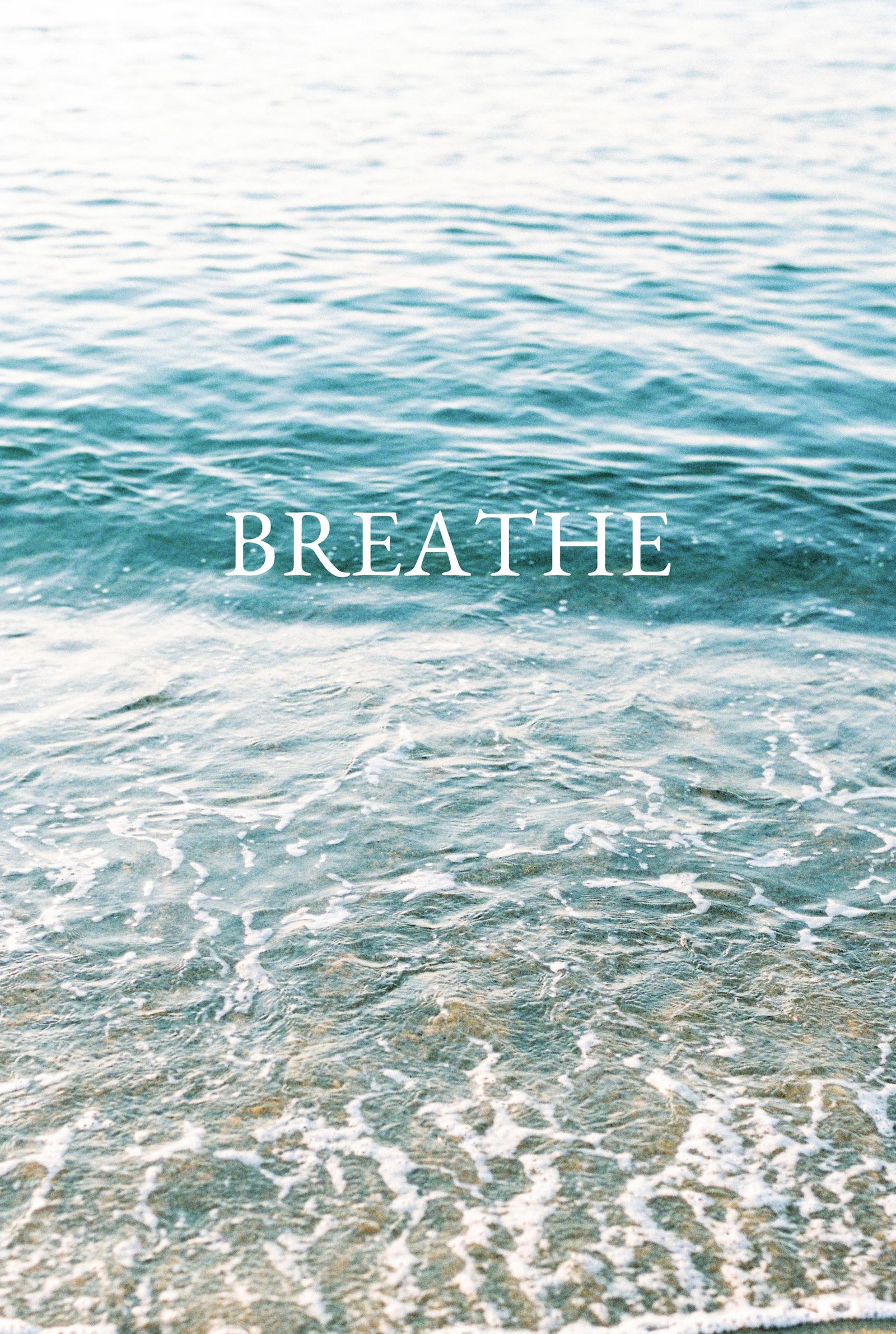 Serene ocean waves with 'Breathe' text inspire calm and reflection.